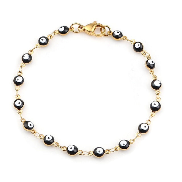 Gold charm bracelet with enamel evil eyes