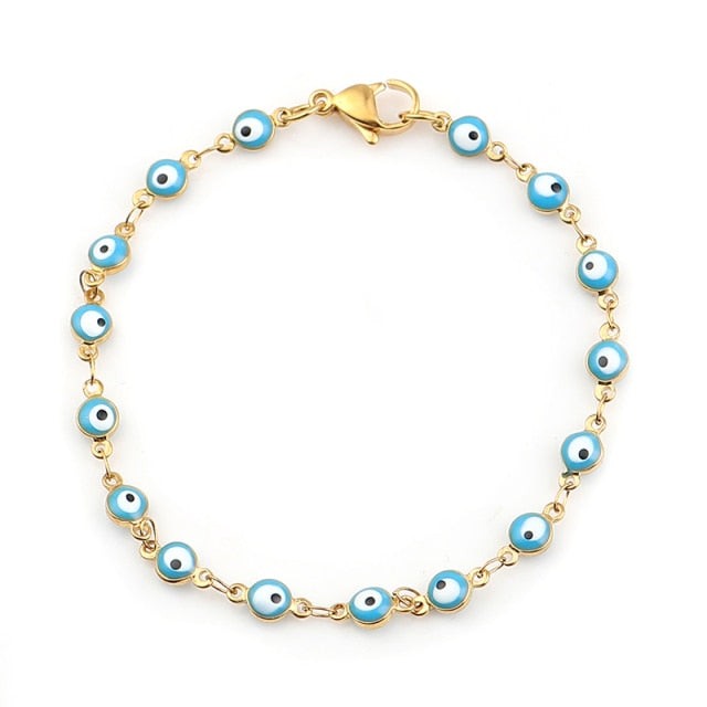 Gold charm bracelet with enamel evil eyes