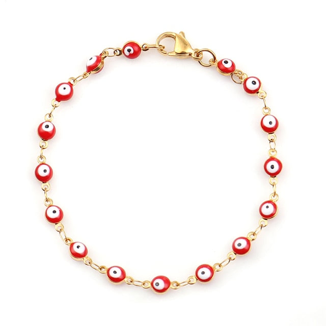 Gold charm bracelet with enamel evil eyes